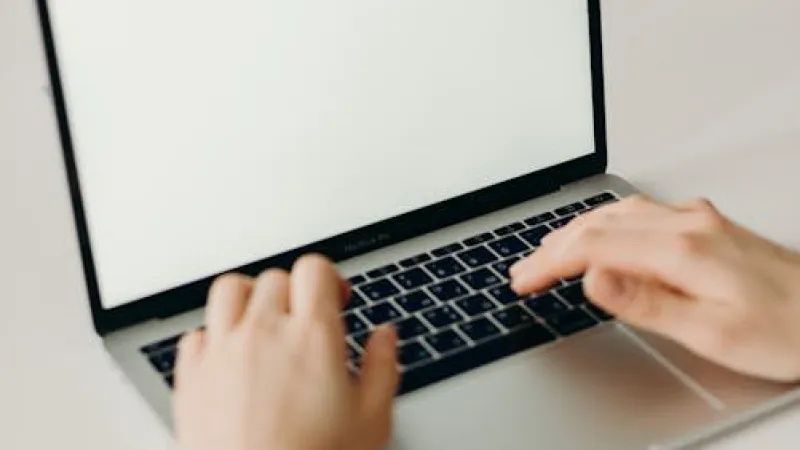 A businesswoman using a laptop to plan the cost of a professional website