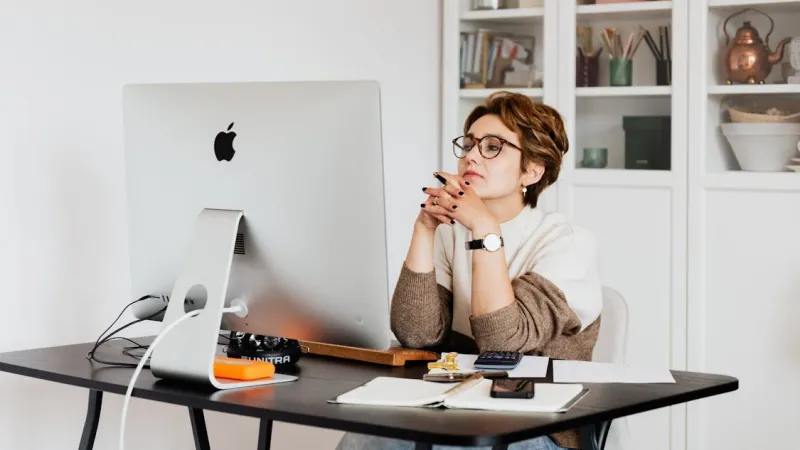 Two laptops on a desk comparing WordPress with a custom-built website