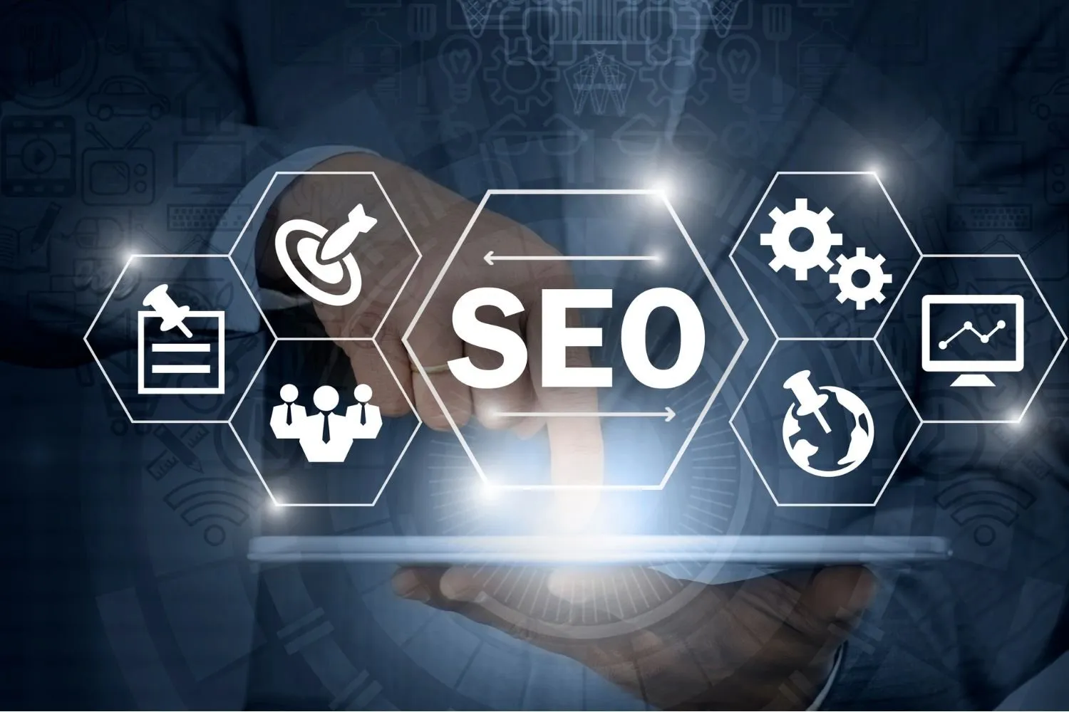 Hand touching a hexagon icon labelled SEO, surrounded by target, team, gear and chart icons above a tablet