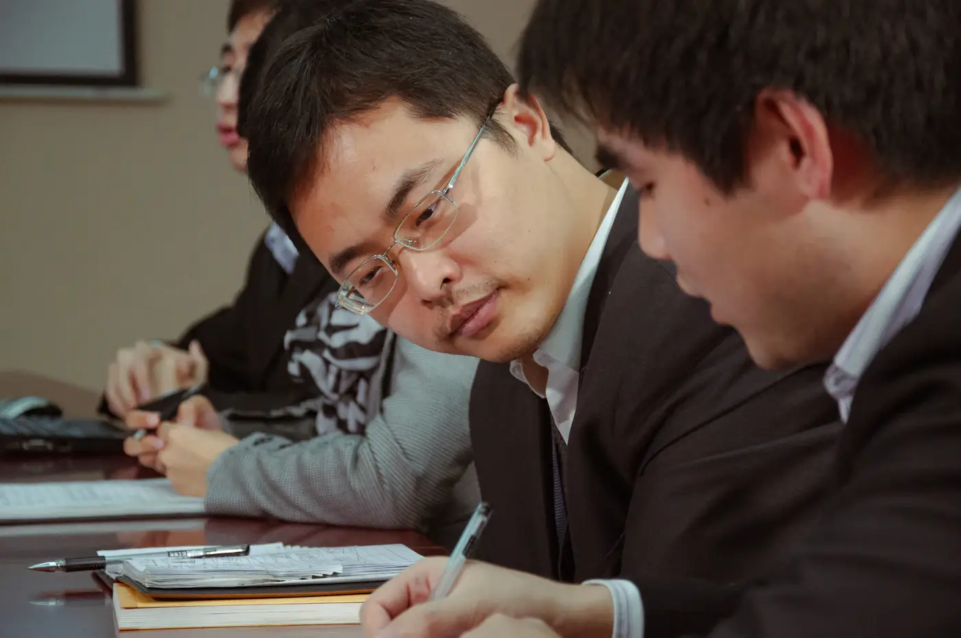 Two people reviewing work documents together