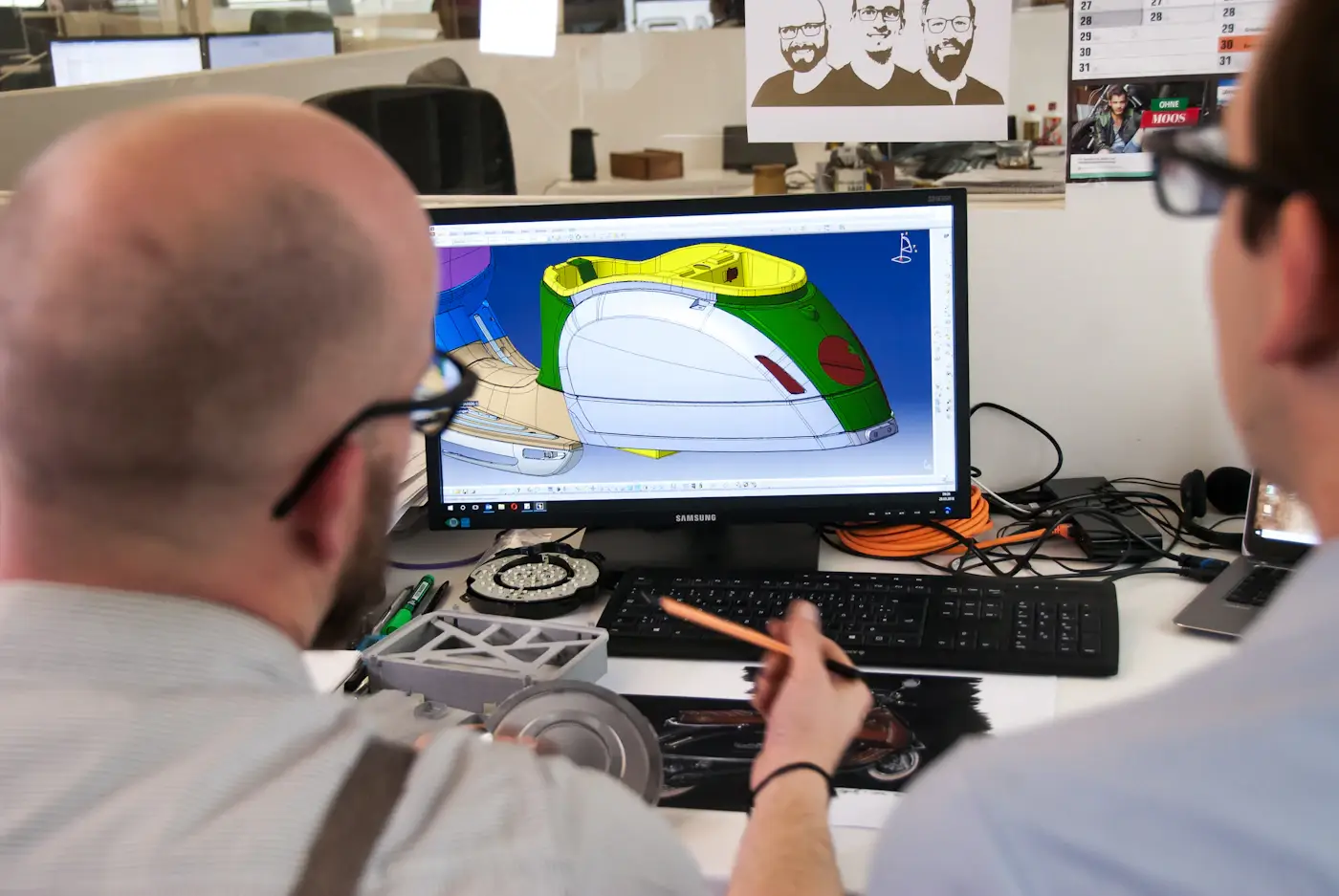 A designer building a 3D model on a computer screen