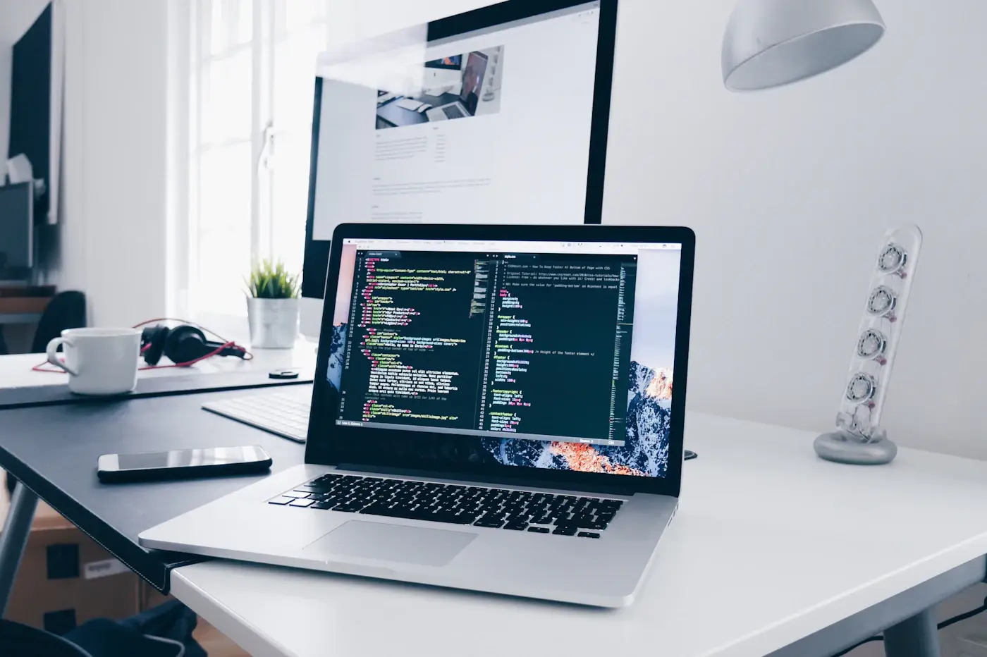 Code on a laptop screen on a work desk