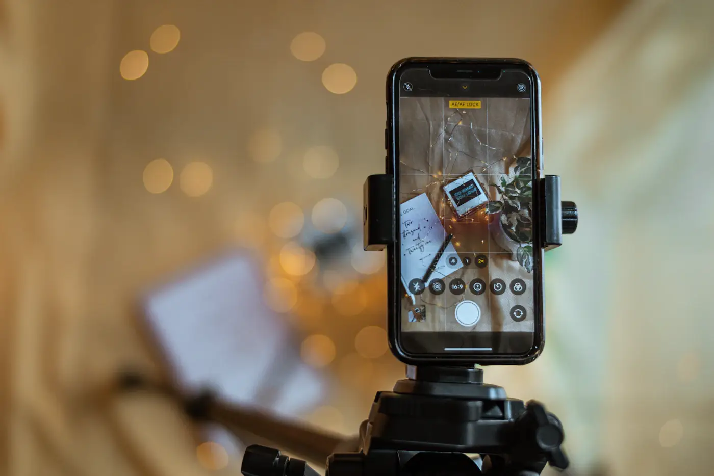 A phone on a tripod, set up to record video content