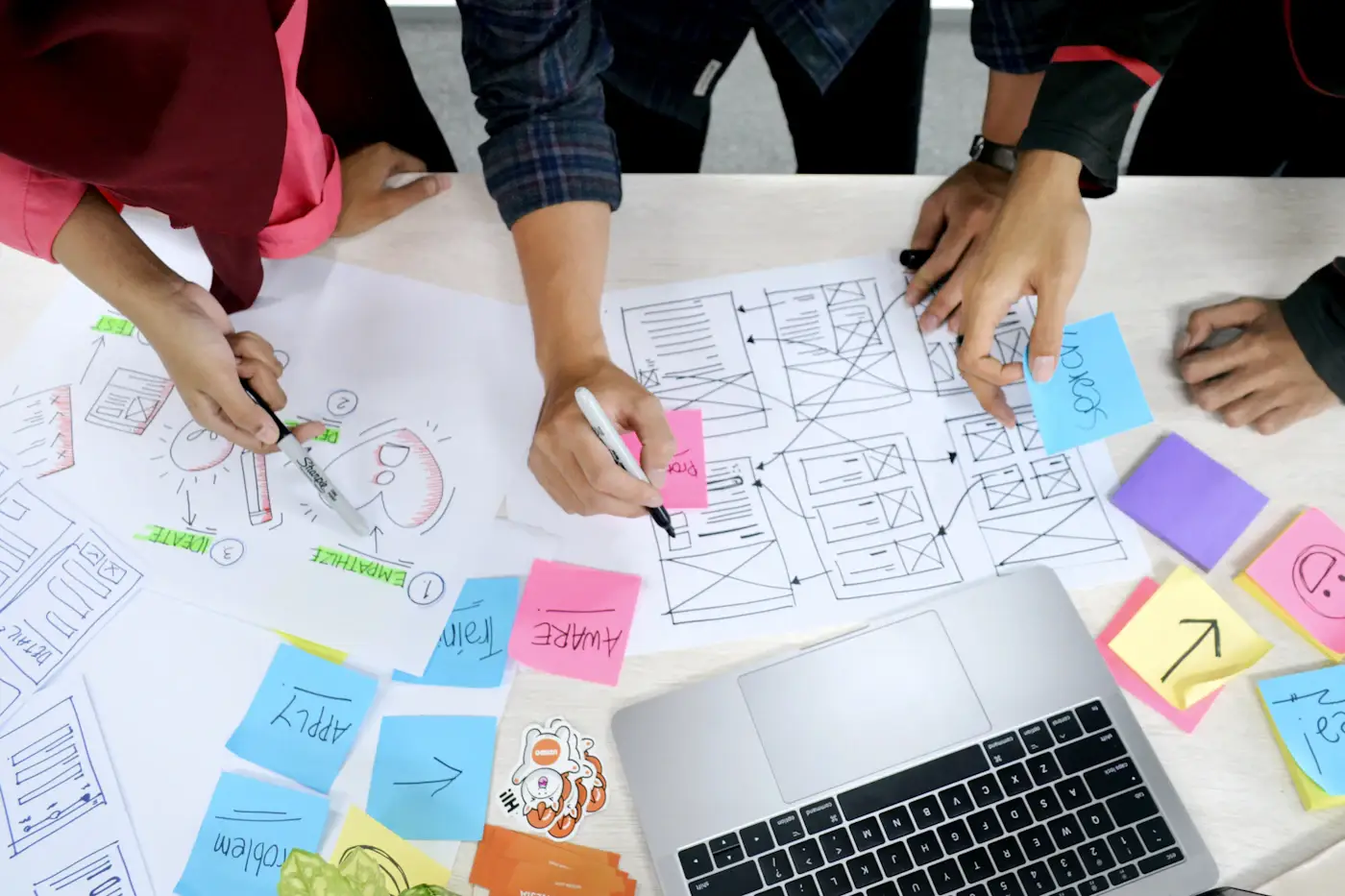 Website page wireframe sketches on a desk
